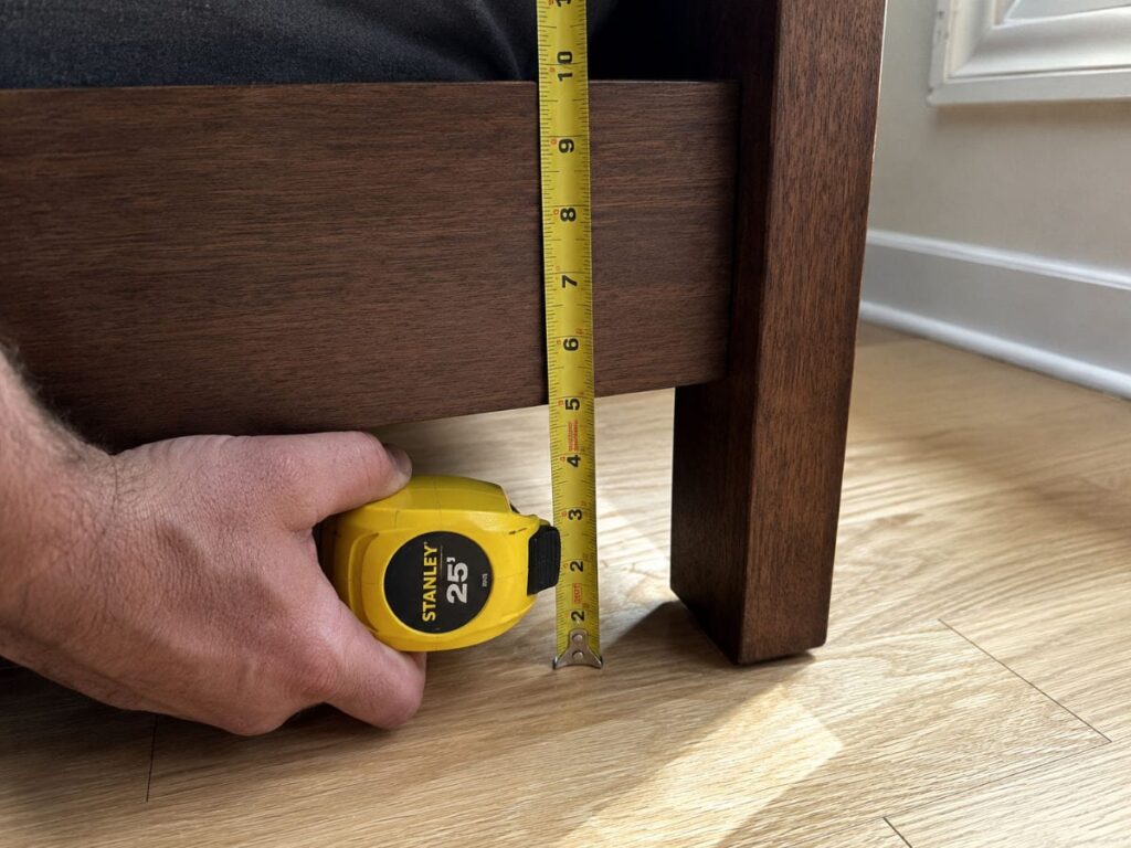 Measuring clearance before setting up under bed storage ideas in a small bedroom