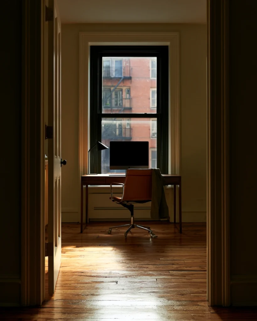Desk placed directly in front of a window, showing why a light source behind you turns everything into a silhouette