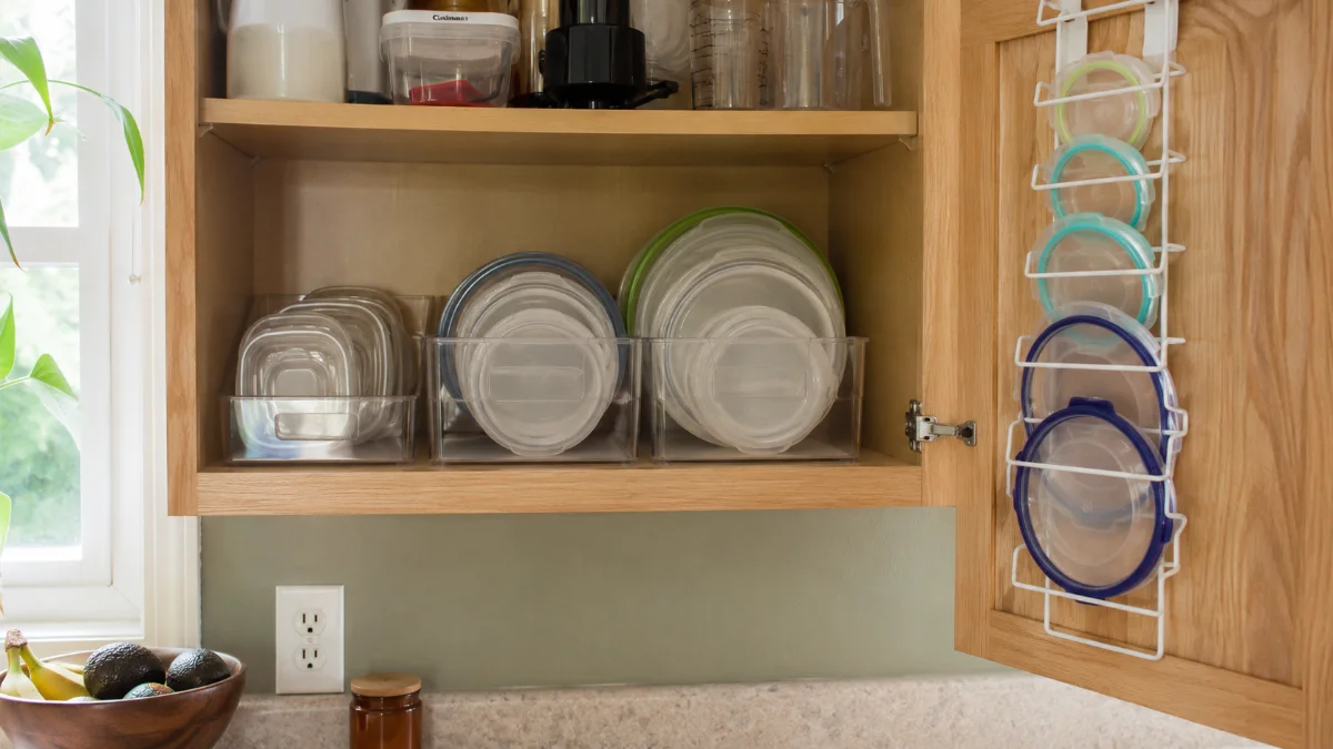 tupperware organization ideas for small kitchens with organized cabinet showing clear bins and over-door lid organizer